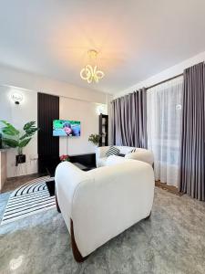 a hotel room with two beds and a tv at West residence in Ruaka