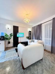 a hotel room with two beds and a tv at West residence in Ruaka