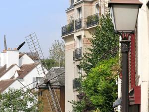 a tall apartment building with a fire escape at Aparthotel Adagio Paris Montmartre in Paris