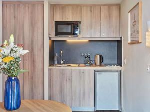 a kitchen with a sink and a microwave at Aparthotel Adagio Aix-en-Provence Centre in Aix-en-Provence