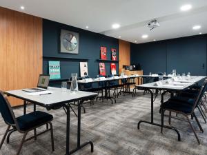 a conference room with tables and chairs with laptops at ibis Styles Nancy Centre Gare in Nancy