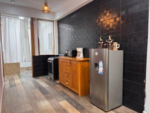 a kitchen with a stainless steel refrigerator and a stove at Apartamento REFUGIO DEL LAGO in San Pedro La Laguna