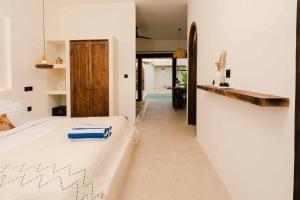 a bedroom with a bed and a hallway at Rumah Mana Villa in Tabanan +24 photos