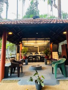 a patio with chairs and tables in a building at Twin Retreat in Madikeri