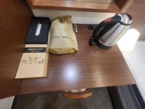a table with a coffee maker and a bag on it at LUVO Signature Hotel in Seoul