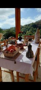 a picnic table with baskets of food on it at Konaku Zenelaj Selcke e Madhe Memaliaj in Polisi i Vogël
