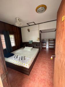 a bedroom with a bed and a desk in it at Blue Lotus Resort in Ban Tai +114 photos
