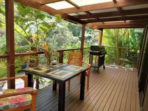 a screened in porch with a table and a grill at Limpinwood Lodge in Limpinwood +25 photos