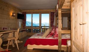 a bedroom with a bed and a desk and a window at Le Bristol - Villars Bristol Apartments in Villars-sur-Ollon