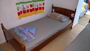 a small wooden bed with two pillows on it at Alexandros House in Apollonia +53 photos