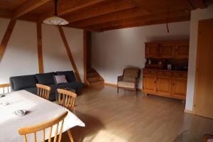 a living room with a table and a couch at Stöckli aux Fontaines in Tramelan +8 photos