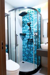 a bathroom with a shower with a toilet and a sink at Rasgrand in Rasdhoo +41 photos