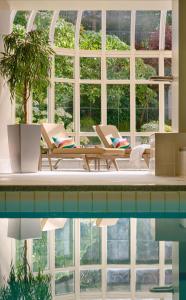a swimming pool with two chairs and a table next to a window at InterContinental Dublin by IHG in Dublin
