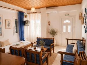 a living room with a couch and a table at Meltemi Apartments in Elafonisos
