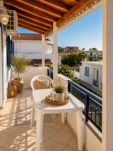 a white table on a balcony with a view at Meltemi Apartments in Elafonisos