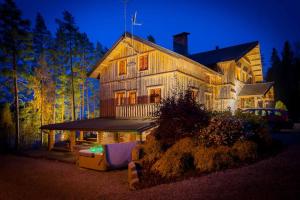a large house is lit up at night at Rapukartano in Mänttä