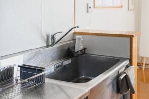 a kitchen sink with a dish drying rack next to it at Building D - Vacation STAY 84939v in Bōchū +52 photos