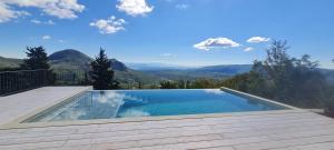 a swimming pool with a view of mountains at Sunrise Lodge in Dapčevići