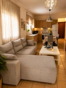 a living room with a couch and a table at Stasa Luxury Apartments in Keramoti