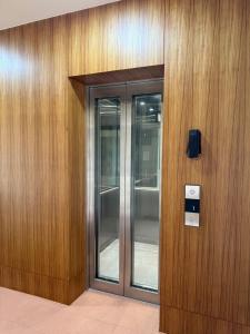 a building with two glass elevators on a wooden wall at Thai House Beach Resort in Lamai
