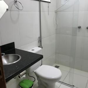 a bathroom with a sink and a toilet and a shower at QualyLeste Hotel in Caratinga