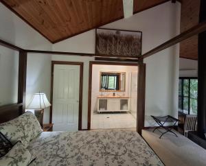 a bedroom with a bed and a living room at Limpinwood Lodge in Limpinwood