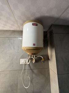 a water dispenser on the wall of a bathroom at Hotel Shyam Mahal Inn in Khātu