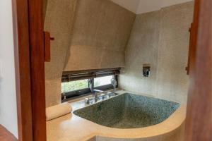a bathroom with a large tub with a window at Mùa Dalat Wellness Hotel in Da Lat +80 photos