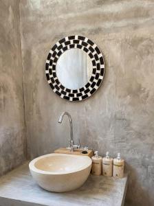 a bathroom with a sink and a mirror at Villa Wakem Yehpoh in Yehpoh +20 photos