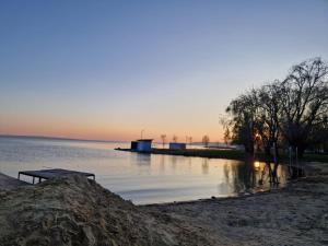 a body of water with a dock in the middle at Réhelyi in Szigliget +2 photos