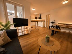 a living room with a couch and a table at Schongau Suites Premium Apartments M in Schongau