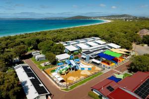 an aerial view of a building with the beach in the background at BIG4 Emu Beach Holiday Park in Albany