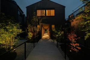 a house with a hallway leading to a building at Mon Hotel HAKATA in Fukuoka