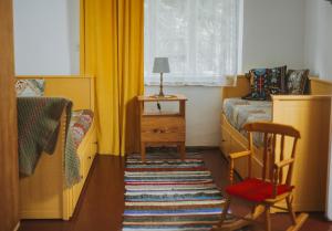 a bedroom with a bed and a table with a chair at Chata w Kamieniu in Kamień +16 photos