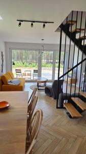 a living room with a couch and a table at Dom nad Zbrzycą MODRY in Swornegacie