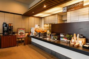 a restaurant with a counter with food on it at Dogo Kan in Matsuyama
