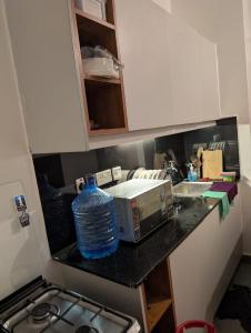 a bottle of water sitting on top of a kitchen counter at Alchemist Homes in Kiambu