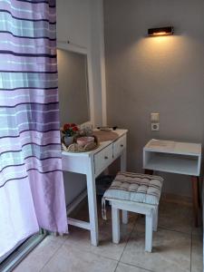 a bathroom with a white sink and a mirror at Doukas in Skala Rachoniou