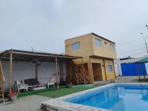 a house with a swimming pool in front of it at Cabañas Punta Negra in Punta Negra