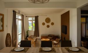 a living room with a table and chairs at Les Manglier in Port Mathurin
