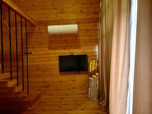 a room with a television on a wooden wall at Golden Coast in Batumi