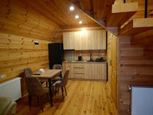 a kitchen and dining room with a table and chairs at Golden Coast in Batumi