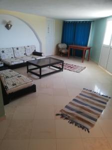 a living room with two couches and a table at Dari in El Haouaria