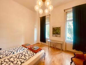 a bedroom with a bed and a desk and a window at Pension Wienderland in Vienna