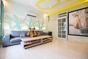 a teddy bear sitting on a couch in a living room at 懶羊羊民宿Cozy Sheep in Chishang