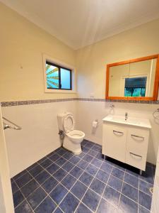 a bathroom with a toilet and a sink at Room 31 in Sydney