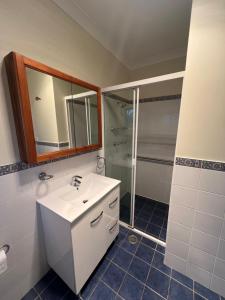 a bathroom with a white sink and a shower at Room 31 in Sydney