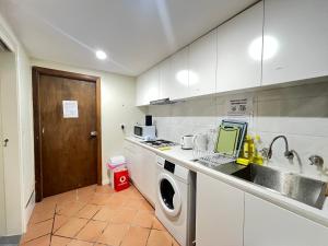 a kitchen with a sink and a washing machine at Room 31 in Sydney