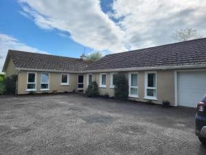 a house with a car parked in front of it at Beech lodge in Wexford