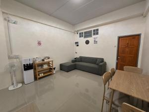 a living room with a couch and a table at Buddy Hostel in Chiang Rai +35 photos